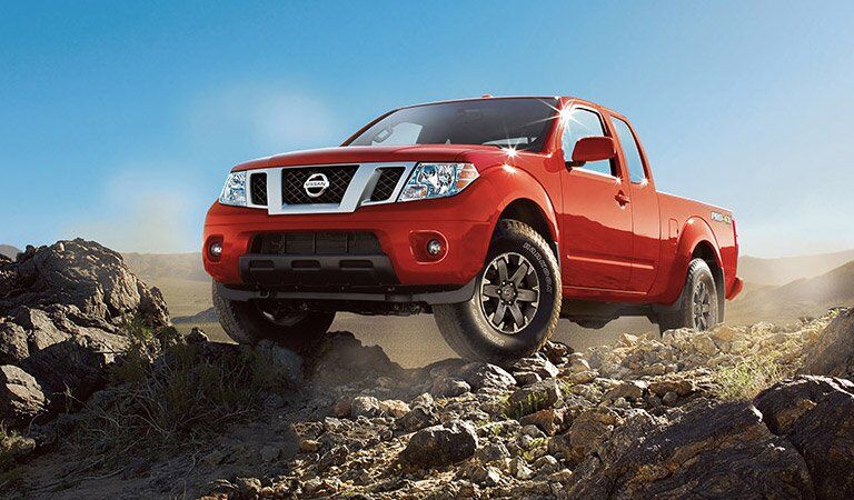 red 2017 Nissan Frontier exterior front on top of rocks