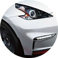 closeup of headlight on white 2017 Nissan 370Z