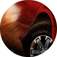 closeup of wheel going through sand on red 2017 Nissan Frontier