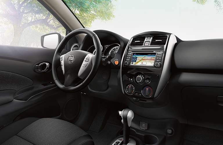 front interior of 2018 nissan versa including steering wheel, windshield and infotainment system