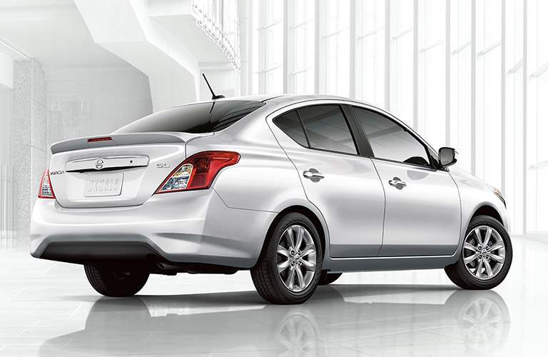 rear view of white 2018 nissan versa against white background