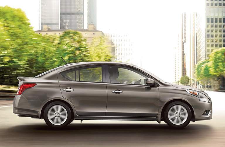 side view of gray 2018 nissan versa in downtown city