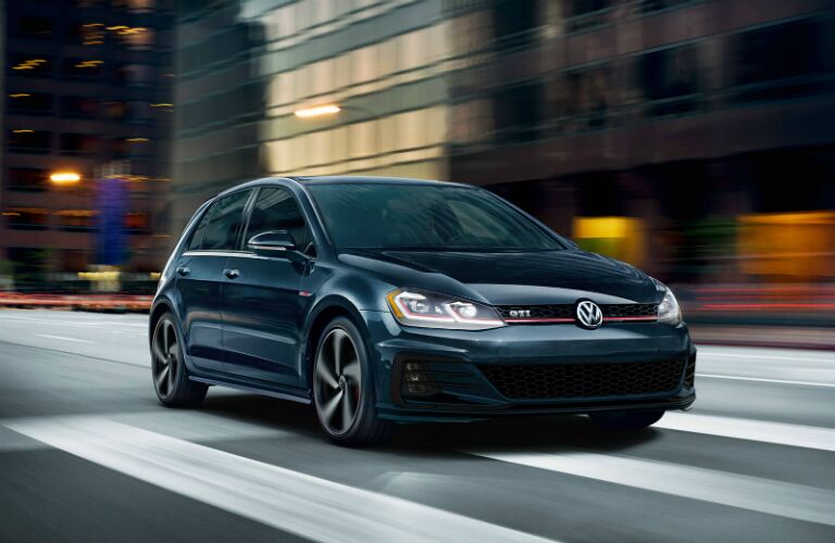 black Golf GTI speeding down city street