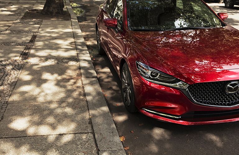 A photo of the left side of the 2018 Mazda6 parked on the side of the street.