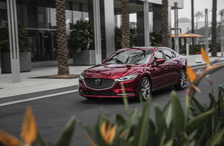 A front right quarter photo of the 2018 Mazda6 parked in front of a building