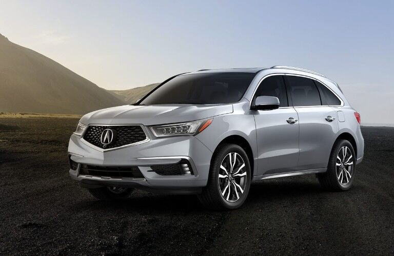 Front driver angle of a white 2020 Acura MDX parked outdoors