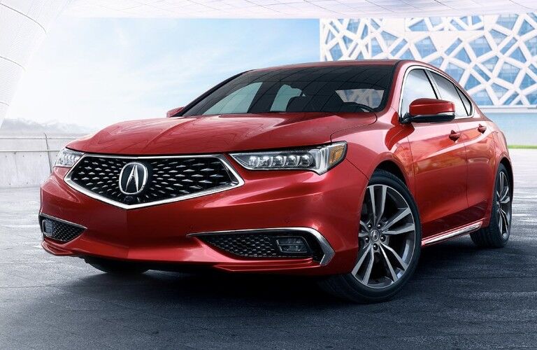 Blue Acura TLX driving through snow