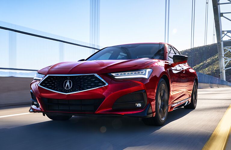 Blue Acura TLX driving through snow