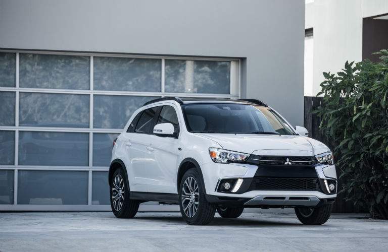 A front view of the 2018 Mitsubishi Outlander Sport in front of a garage door