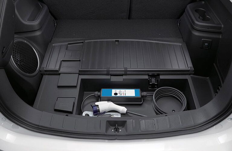 A photo of the cargo area in the 2018 Mitsubishi Outlander PHEV where the charging gear is stored.