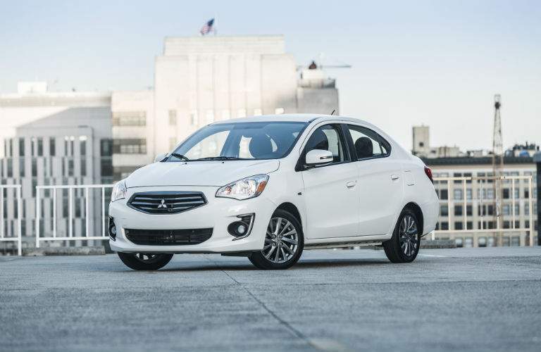 A front left quarter photo of the 2018 Mitsubishi Mirage G4 parked on top of a building.