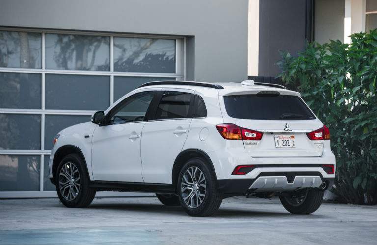A rear quarter photo of a 2018 Mitsubishi Outlander Sport parked in front of a home.
