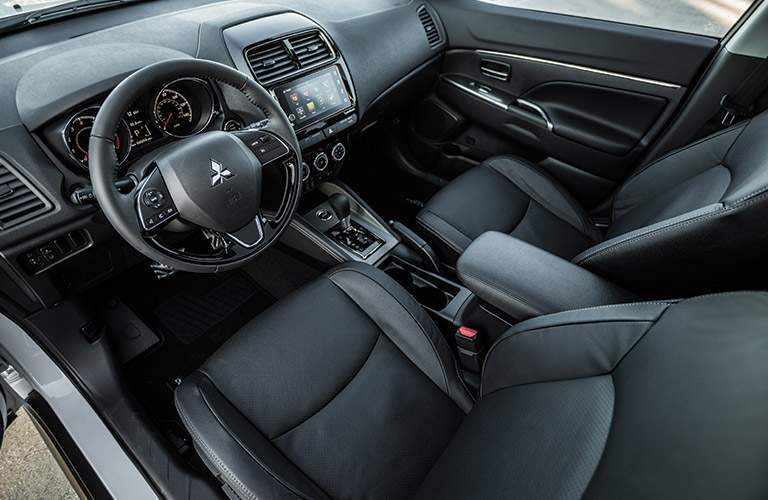A top down view of the drive and front passenger seats in the 2018 Mitsubishi Outlander Sport as well as the center gauge cluster and gear shifter