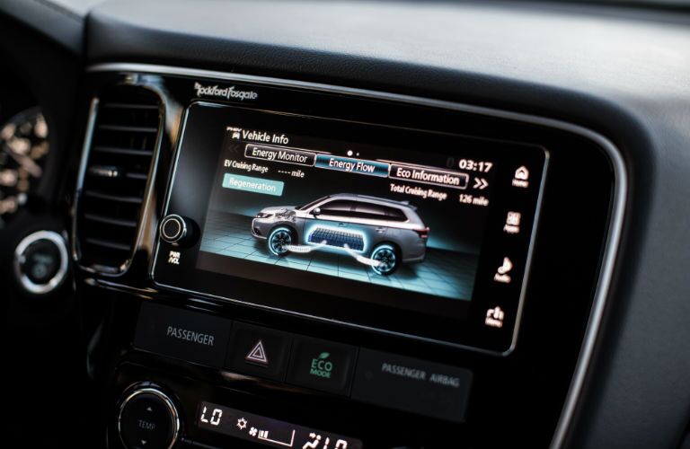 A close up photo of the touchscreen interface of the 2018 Outlander PHEV that can monitor fuel efficiency.
