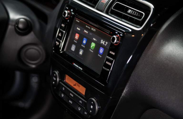 A close up photo of the infotainment system and climate controls in the 2018 Mirage G4.