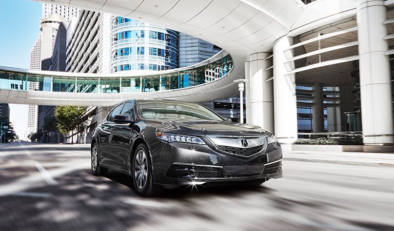 2017 Acura TLX driving through a futuristic city street
