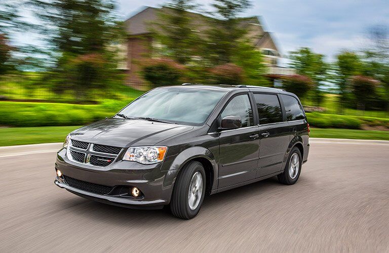 Grey Dodge Grand Caravan driving down the road