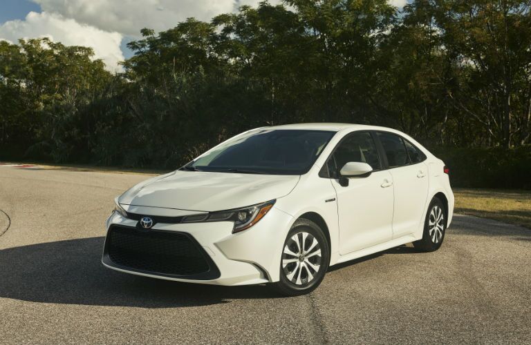 A front left quarter photo of the 2020 Toyota Corolla Hybrid parked on the road.