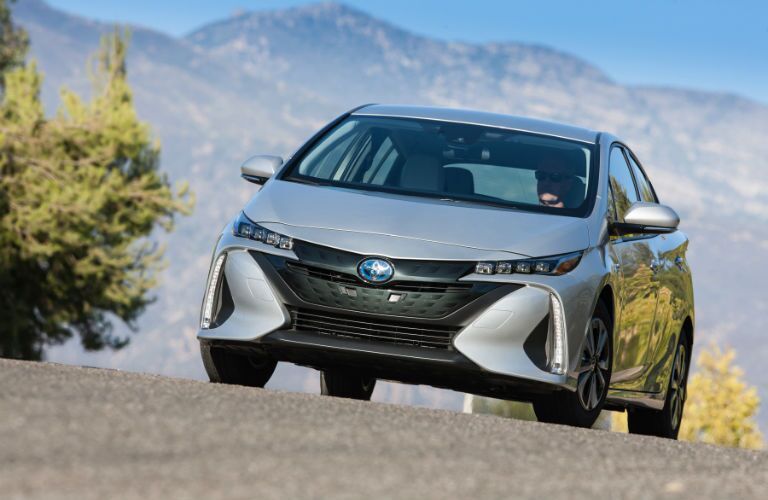 A front end photo of the 2018 Toyota Prius Prime on the road.