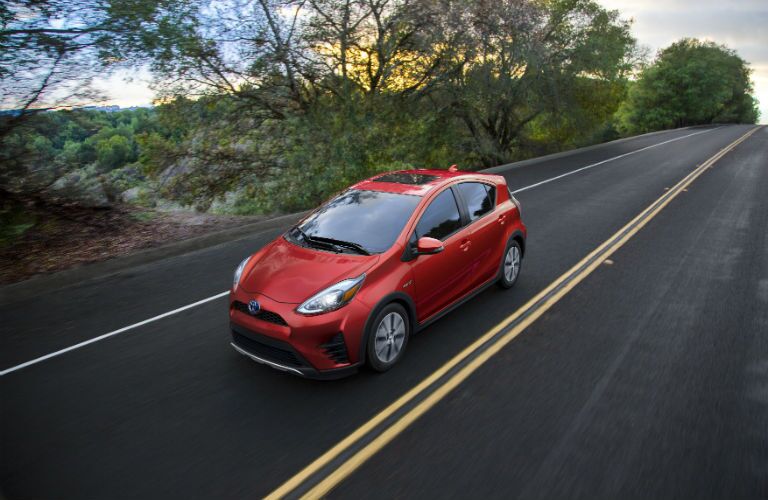 An overhead photo of the 2018 Toyota Prius c driving down the road.
