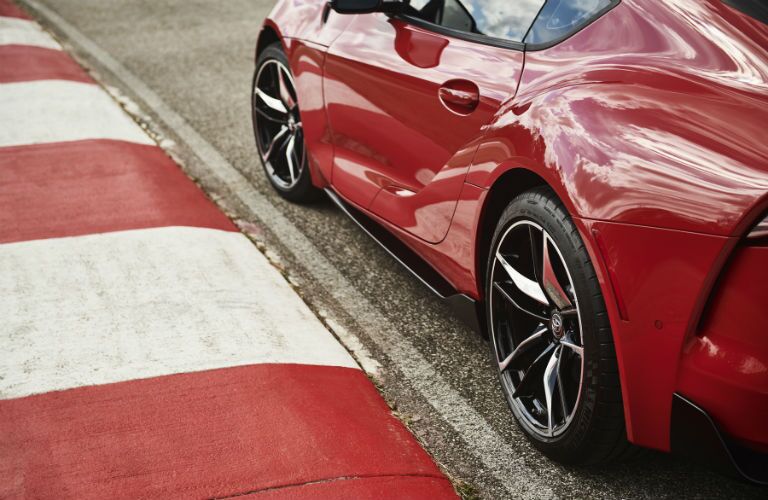 A photo of the 2020 Supra on the side of a race track.