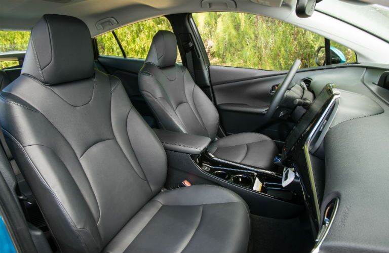 A view of the front seats in the 2018 Toyota Prius Prime from the passenger side.