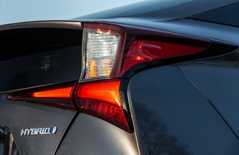 A rear right quarter photo of the 2019 Prius showing its hybrid badge.