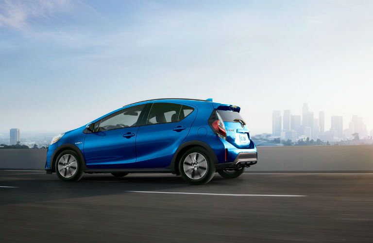 A left profile photo of the 2018 Toyota Prius c on the highway.