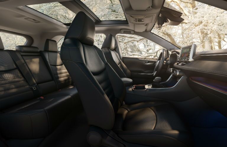 A wider angle photo of the interior of the 2019 RAV4 showing the front and rear seats.