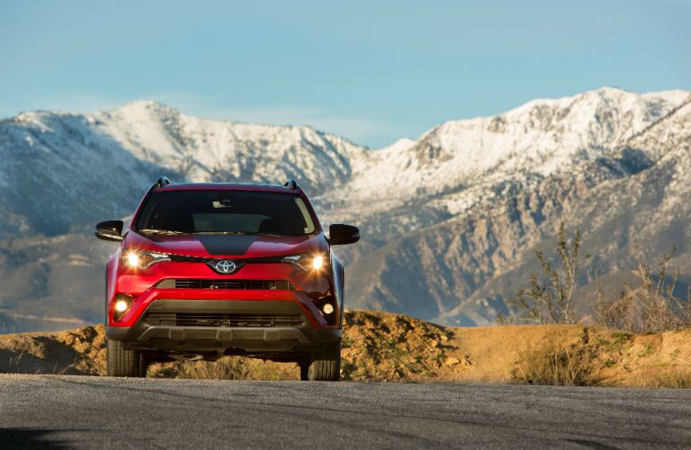 A head-on photo of the 2018 Toyota RAV4 Adventure parked in front of mountains.