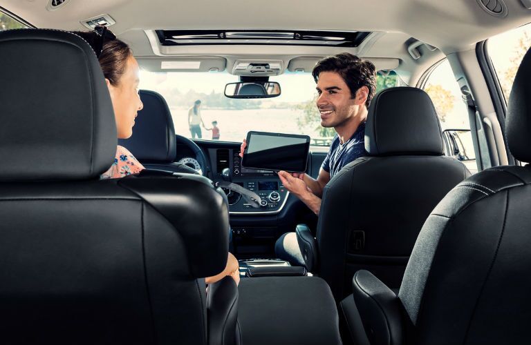 A photo of people using the Wi-Fi hotspot in the 2019 Toyota Sienna.