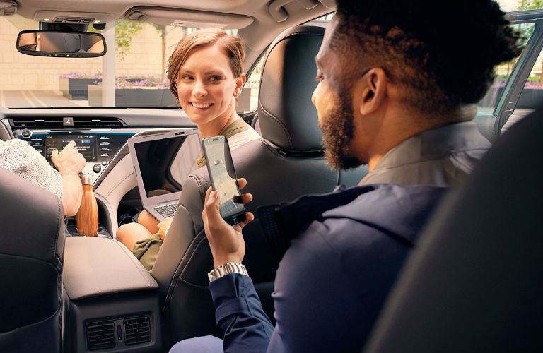 A photo of people using the Wi-Fi hotspot in the 2019 Toyota Camry.