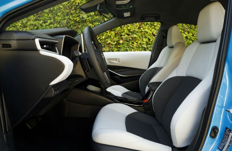 An interior photo of the front seats in the 2019 Corolla Hatchback.
