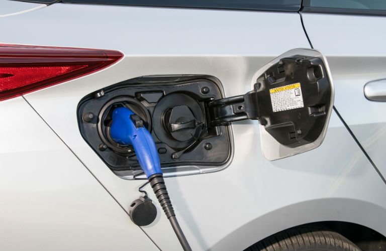 A photo of the 2018 Toyota Prius Prime being charged via a special unit.