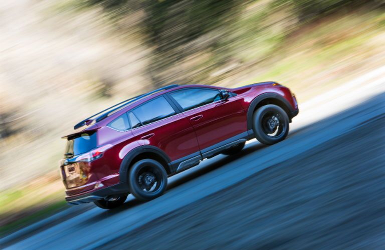 A right profile photo of a 2018 Toyota RAV4 Adventure in motion on the road.