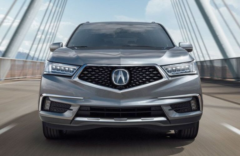 Front view of 2019 Acura MDX driving over bridge
