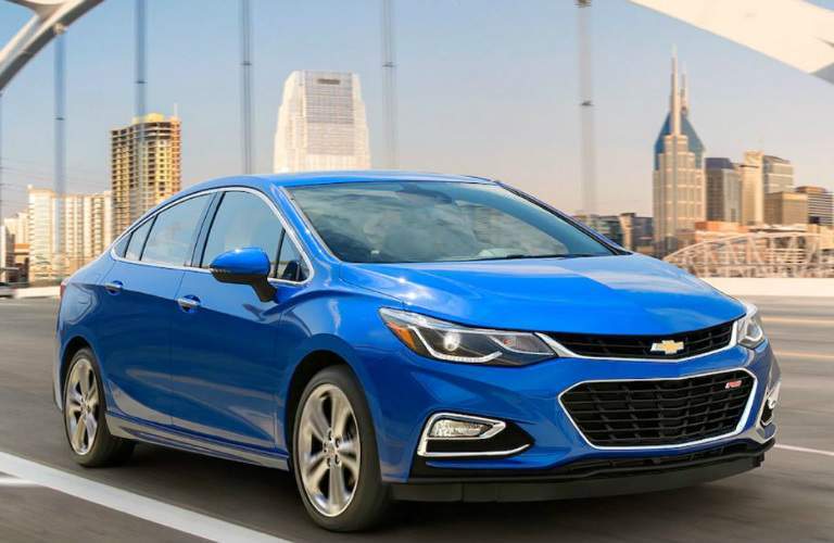 blue 2018 Chevy Cruze driving along bridge