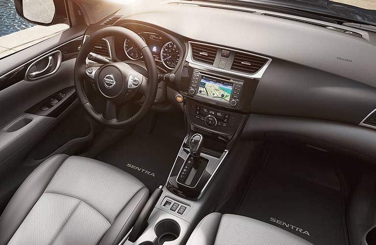 front interior of 2018 nissan sentra including steering wheel, dashboard and infotainment system