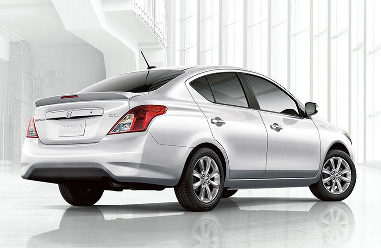 rear view of white 2018 nissan versa against white background