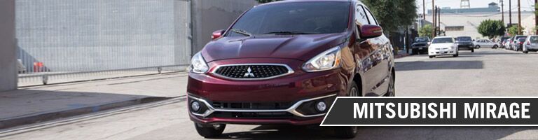 2017 Mitsubishi Mirage driving in a city with vehicles behind it
