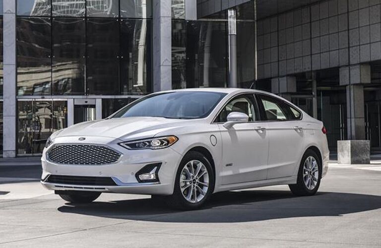 White 2019 Ford Fusion parked in front of modern building