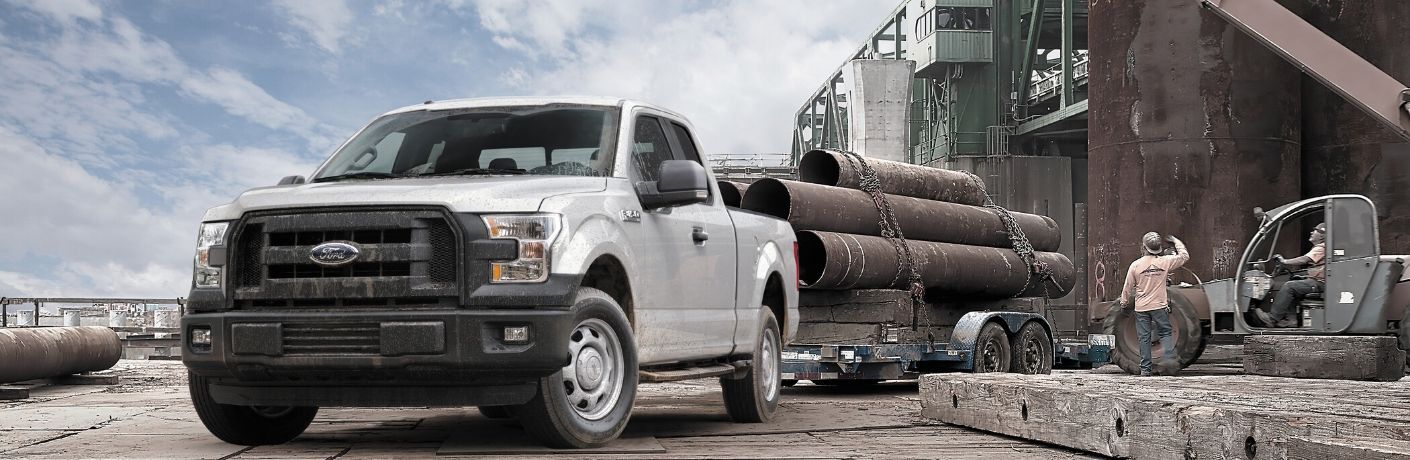 2015 Ford F-150 hauling trailer on construction side