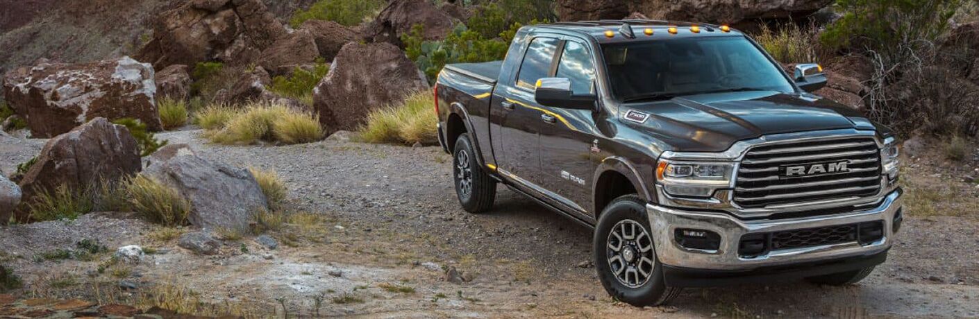 A photo of a used RAM 2500 parked in the wilderness.