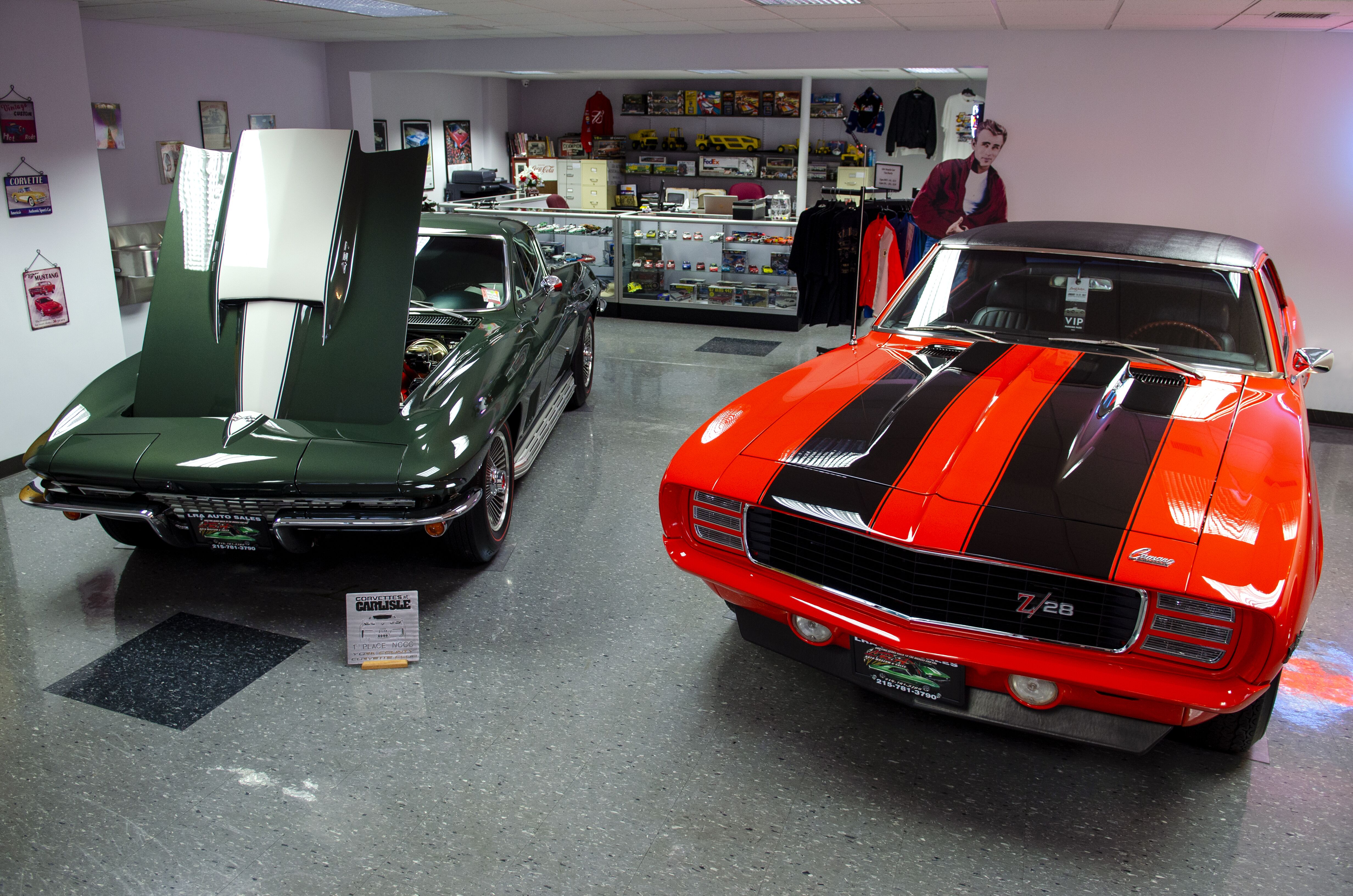 classic vehicle with hood up in showroom