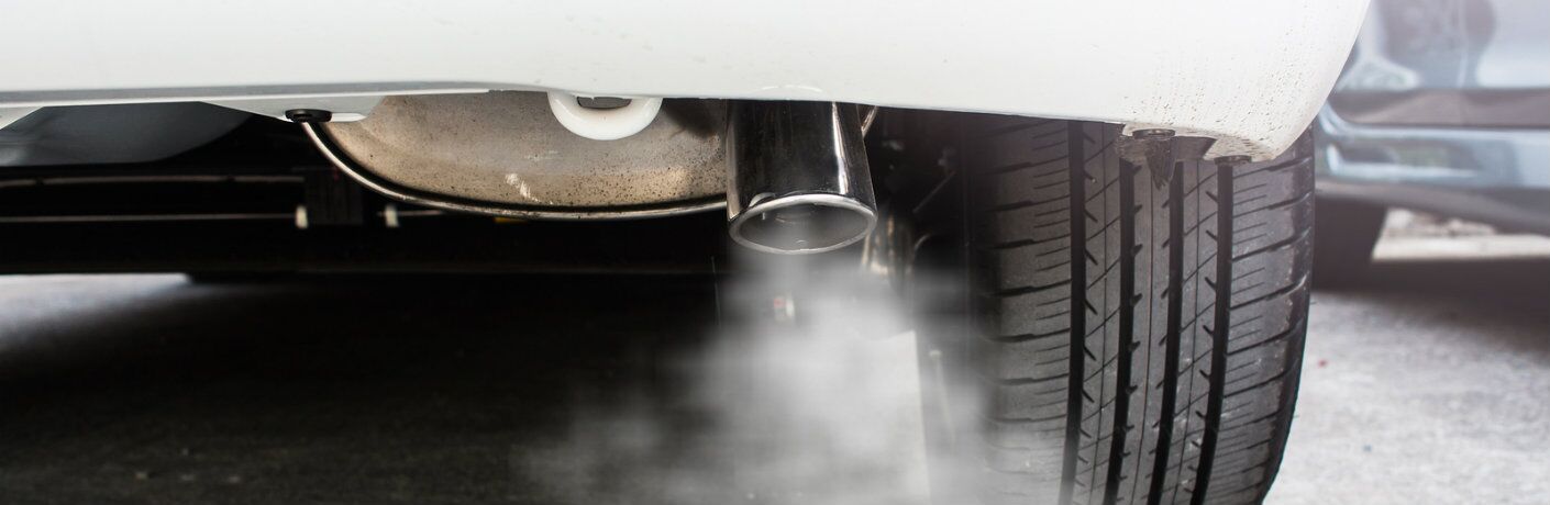 Isolated view of exhaust smoke coming from vehicle tailpipe