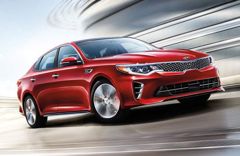 An artist's rendering of a red Kia Optima in motion