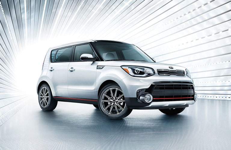 A photo illustration of a white Kia Soul in a gradient tunnel