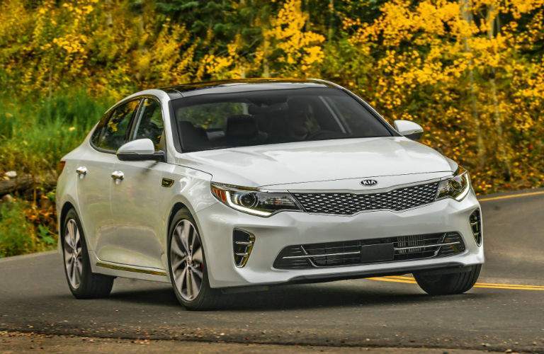 A front view of a white 2018 Kia Optima parked on the road