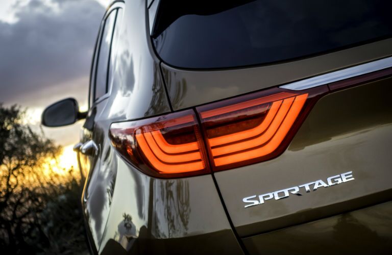 A close up photo of the Sportage badge on the back of the 2018 Kia Sportage.