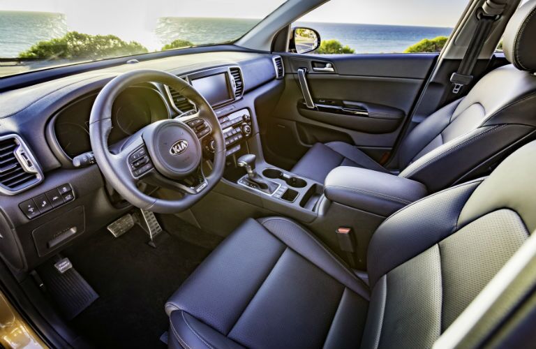 An interior photo of the driver's cockpit in the 2018 Kia Sportage.